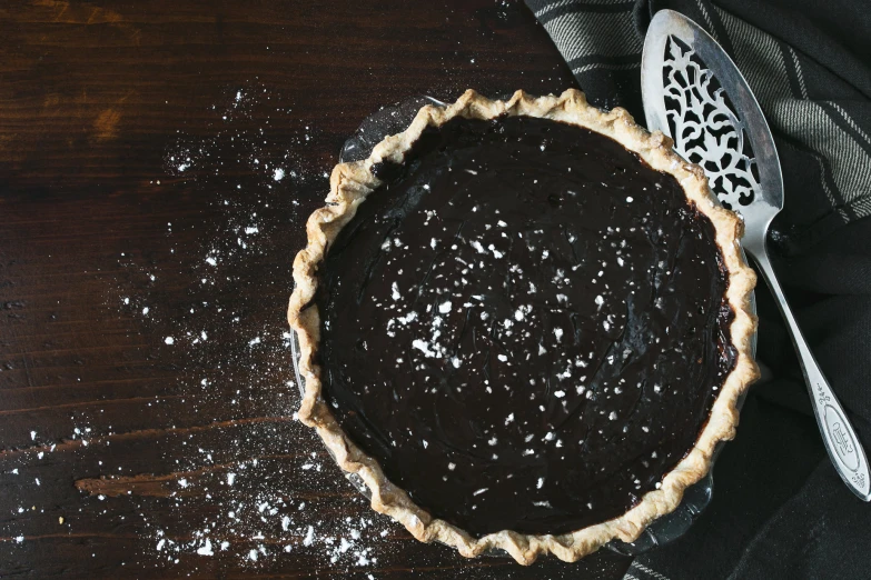 a chocolate pie sits in a tarp on a table