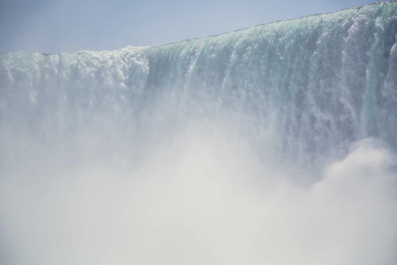 people in skis are walking over a water fall