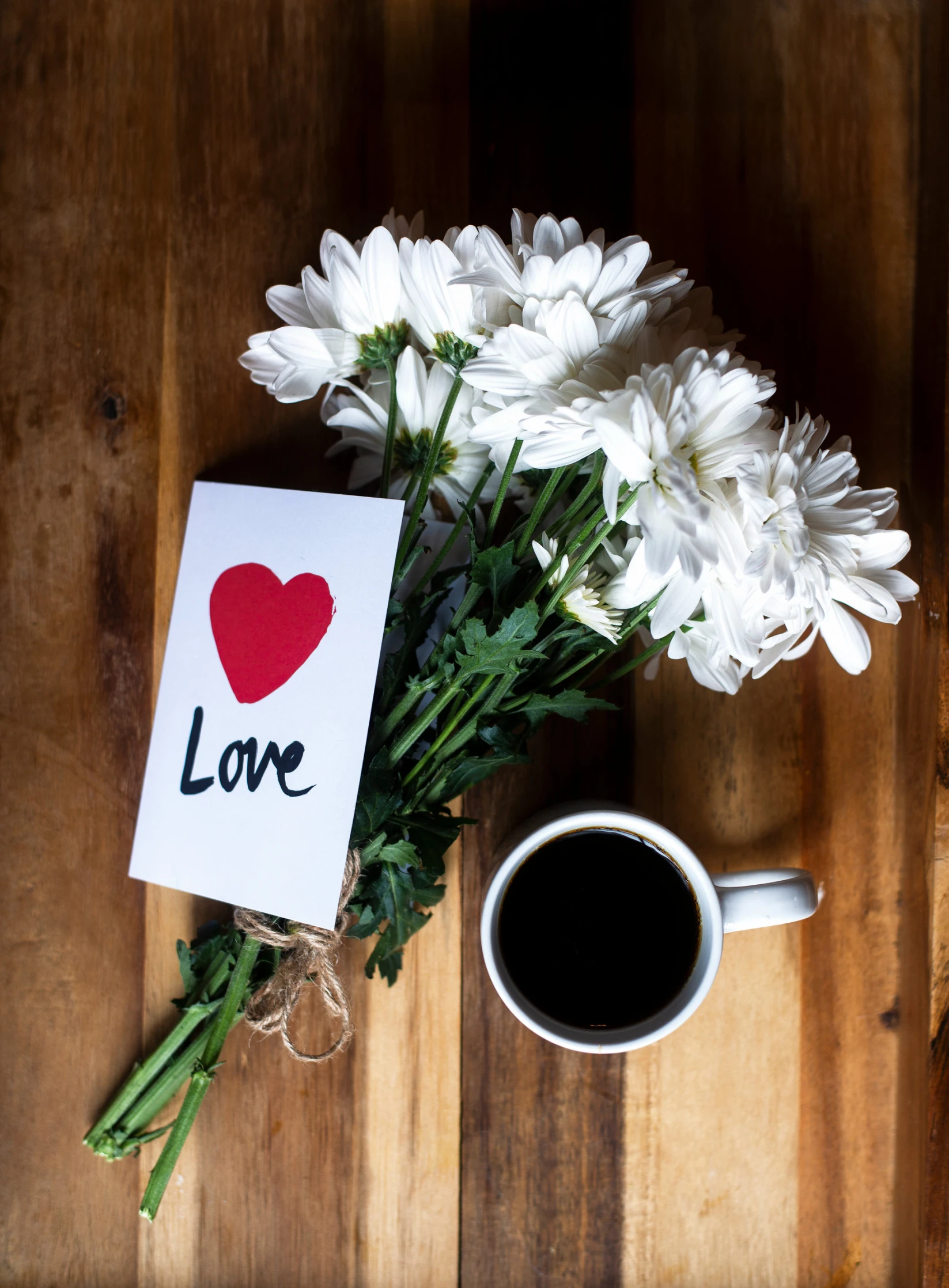 bouquet of flowers on the table with a coffee