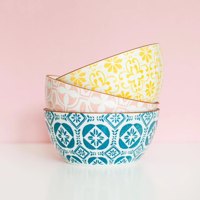 four bowls sitting on top of a white table