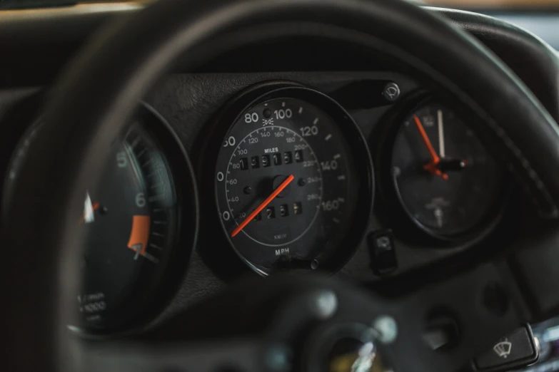 the dashboard of a car with red and black lights