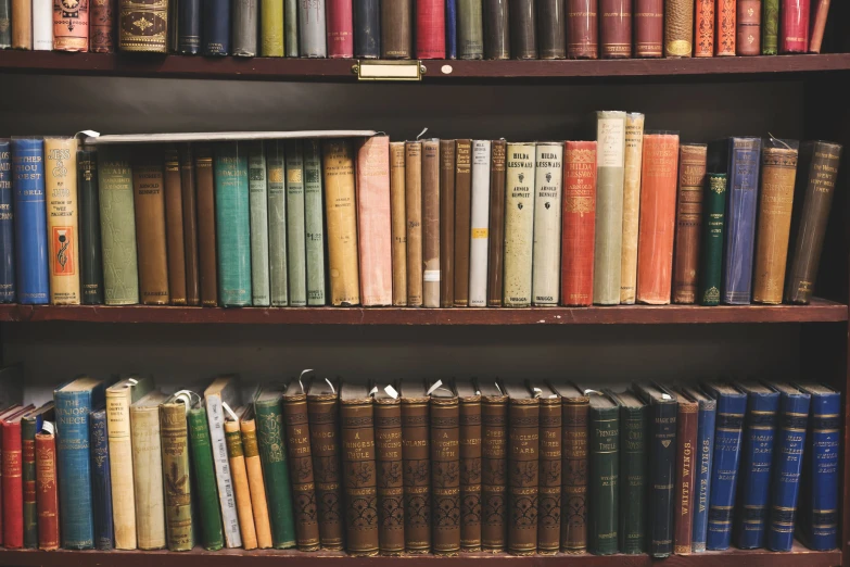 a bookshelf filled with lots of books on top of it