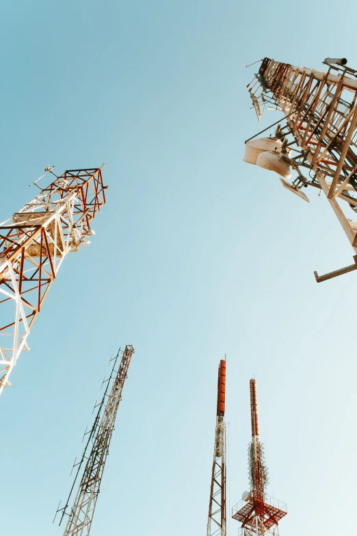 some cell towers with the sky in the background