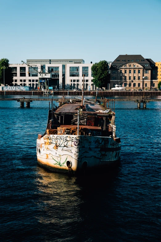 an old boat is in the middle of the water