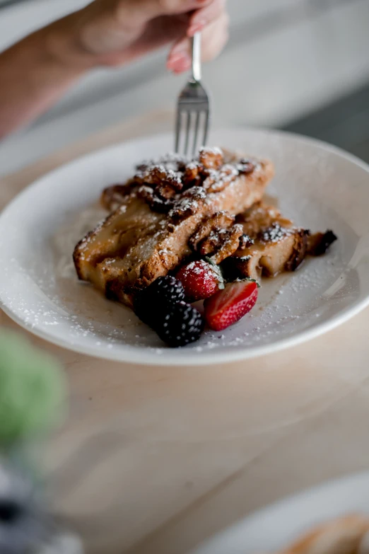 a plate full of french toast and strawberries