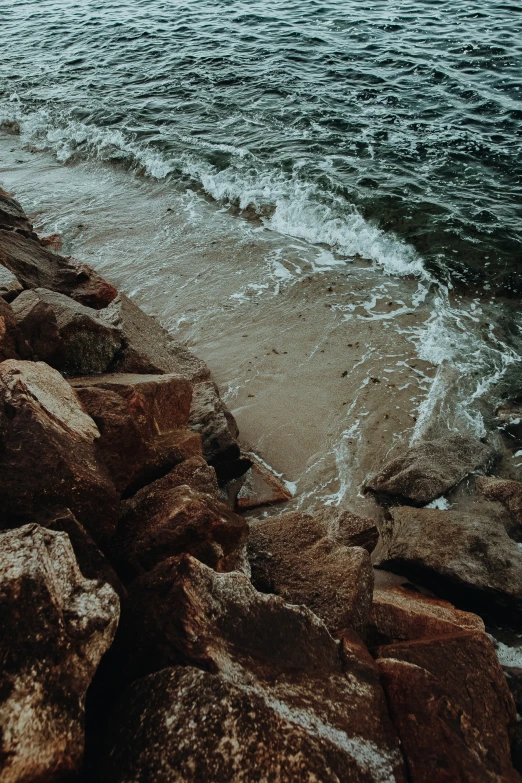 an ocean view with rocks on one side and water on the other