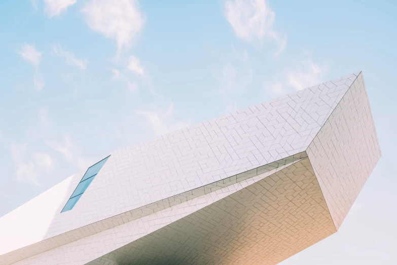 the roof of a building is white and has many windows