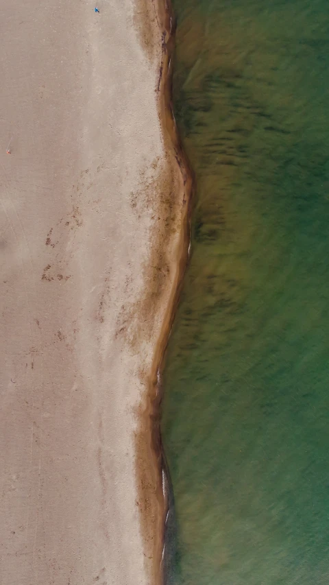 an aerial view of the shoreline of the ocean