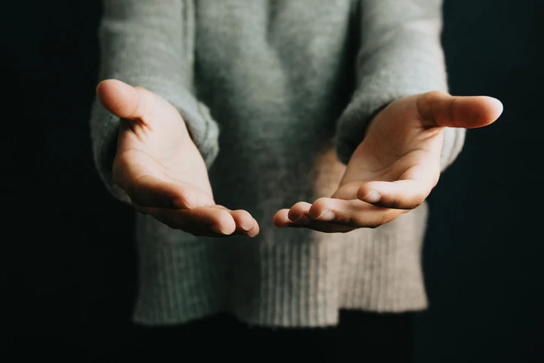 a woman is shown being cupped in open hands