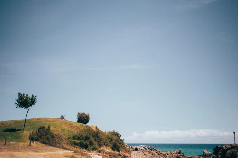 two people are riding bicycles down the hill