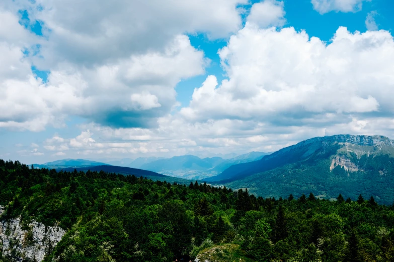 a large mountain range under cloudy skies