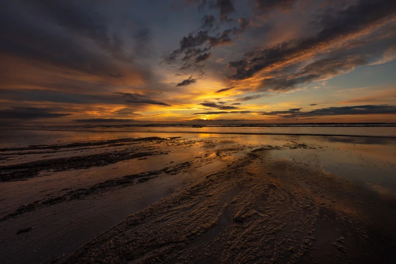 a very colorful sky with some water and clouds