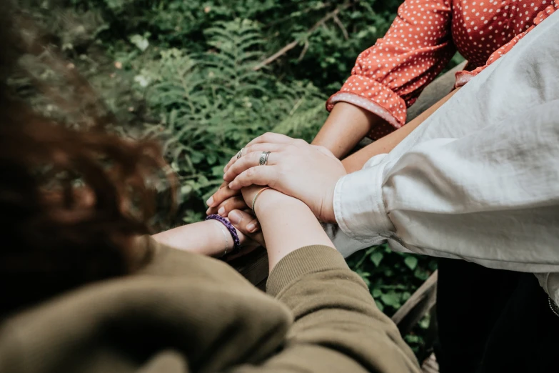 people holding hands and reaching for each other