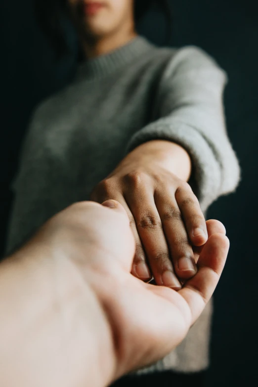 a person holding onto the arm of another hand