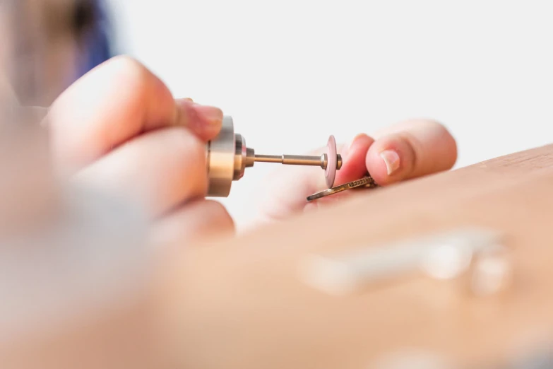 a close - up s of a person's hand using screwdrivers