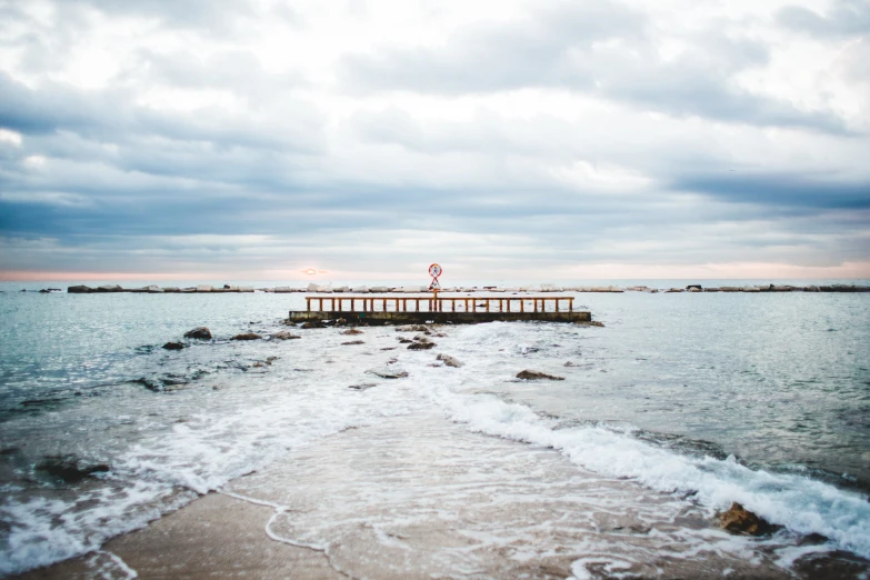 there is an ocean pier and a sign that says no swimming in it