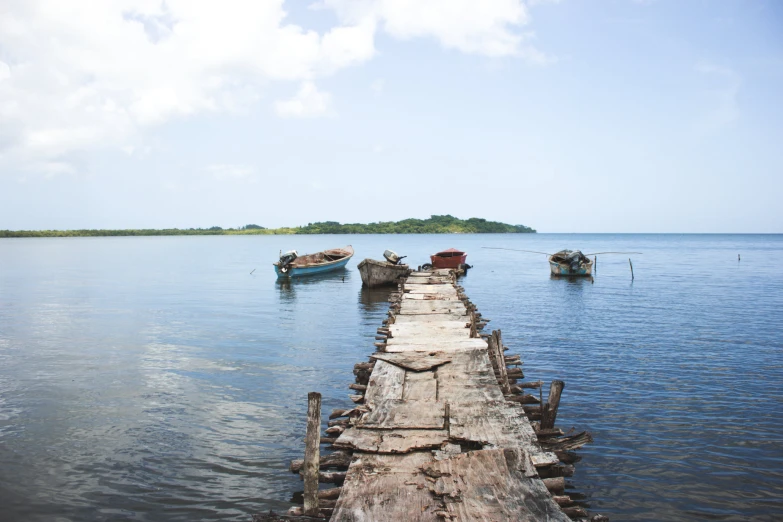 a long boat is docked at the end of a pier