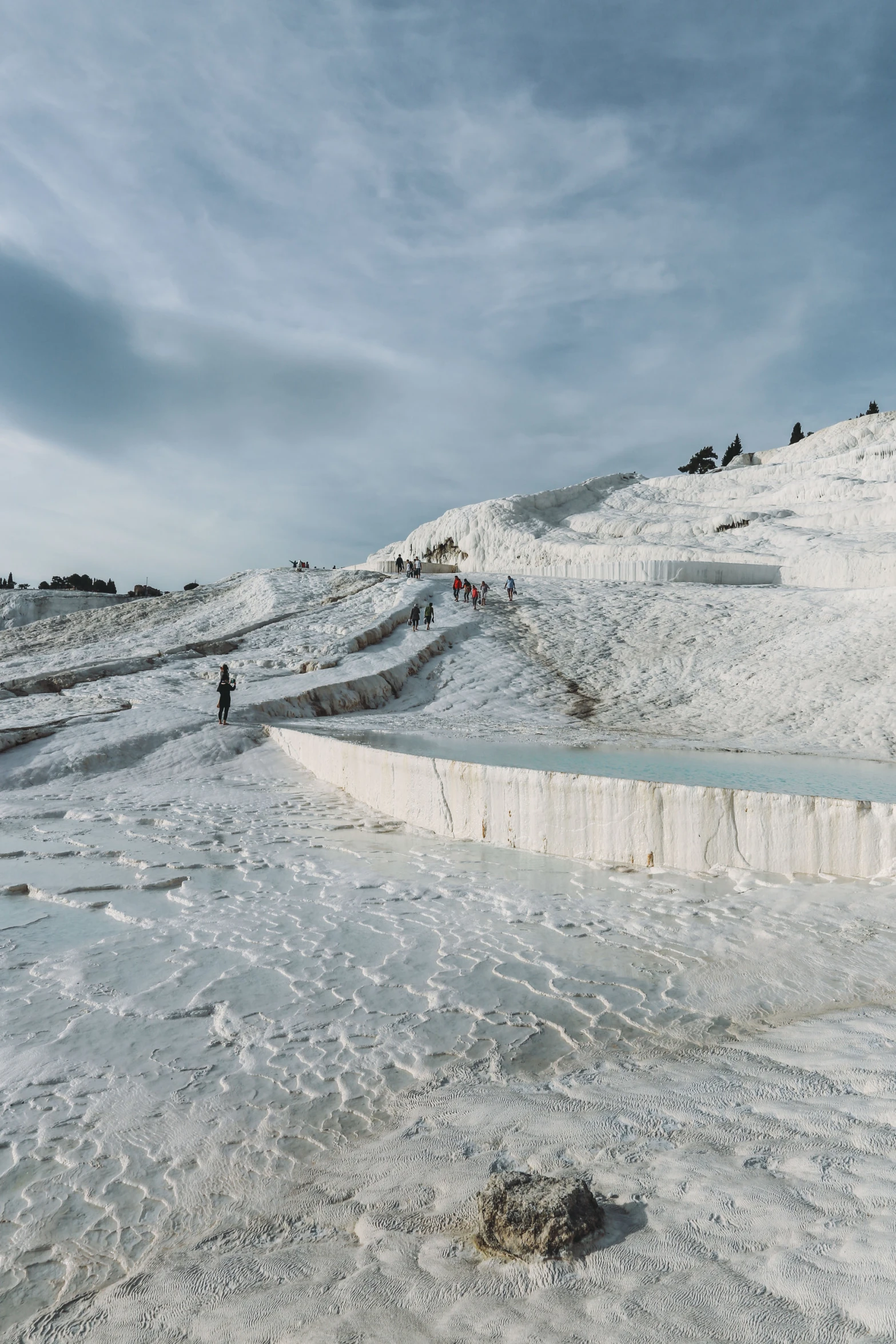 several people standing on top of a snowy hill