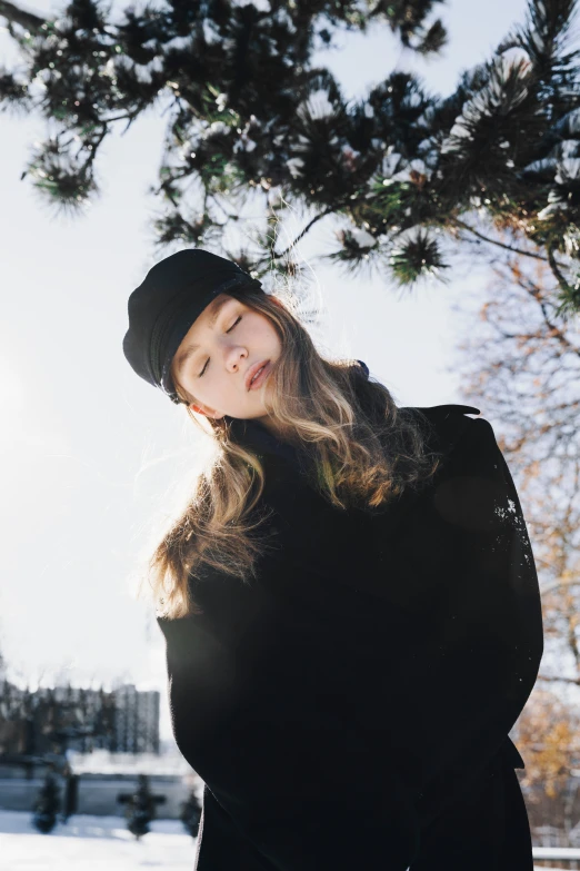 a young woman in black is sitting outside