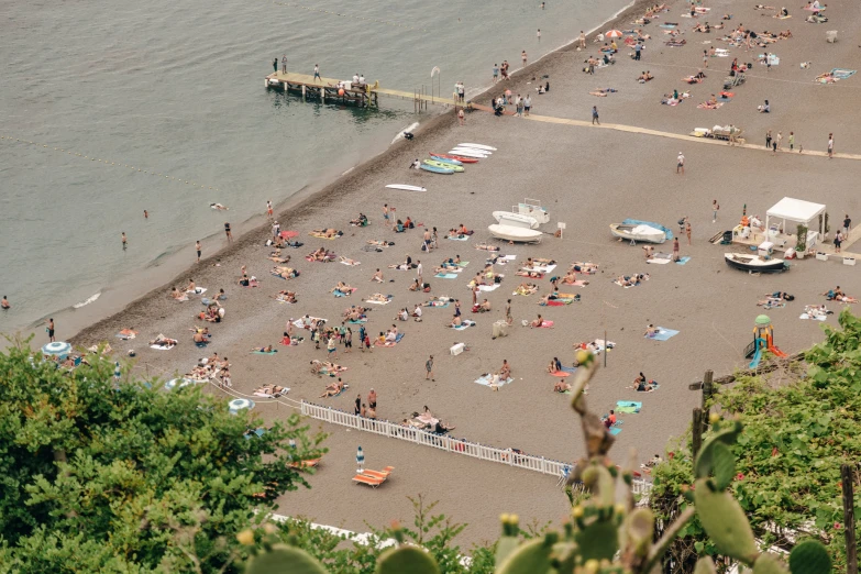 many people on a beach next to the water