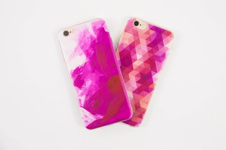 two cell phones covered in pink and purple colors on top of each other