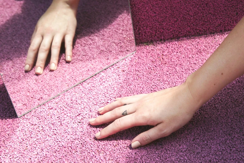 the hands of two people who are standing on a rug