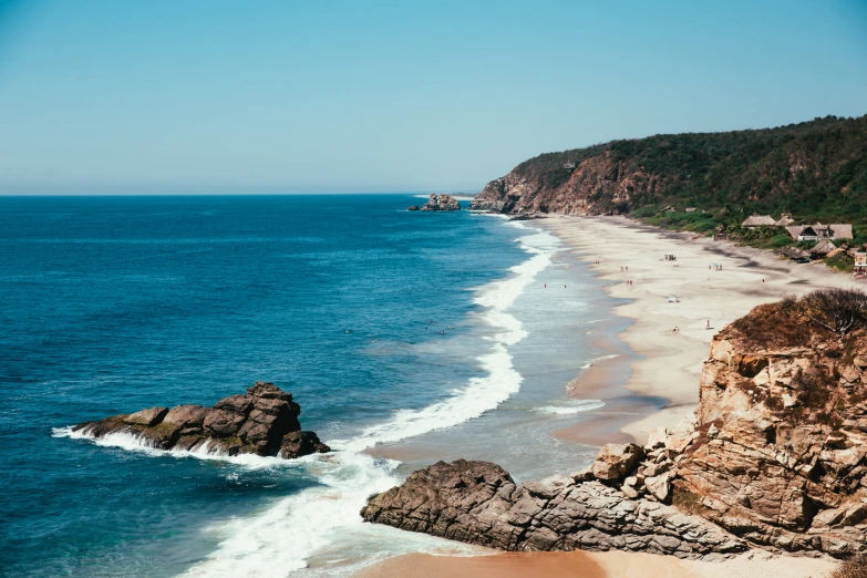 a beach area has a body of water and waves