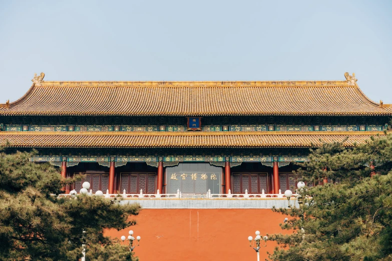 a tall building with a door near trees