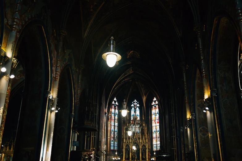 the inside of a church with lights shining