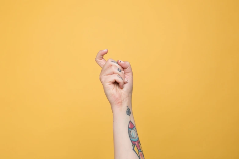 a woman's arm is decorated with tattoos and holding onto her phone