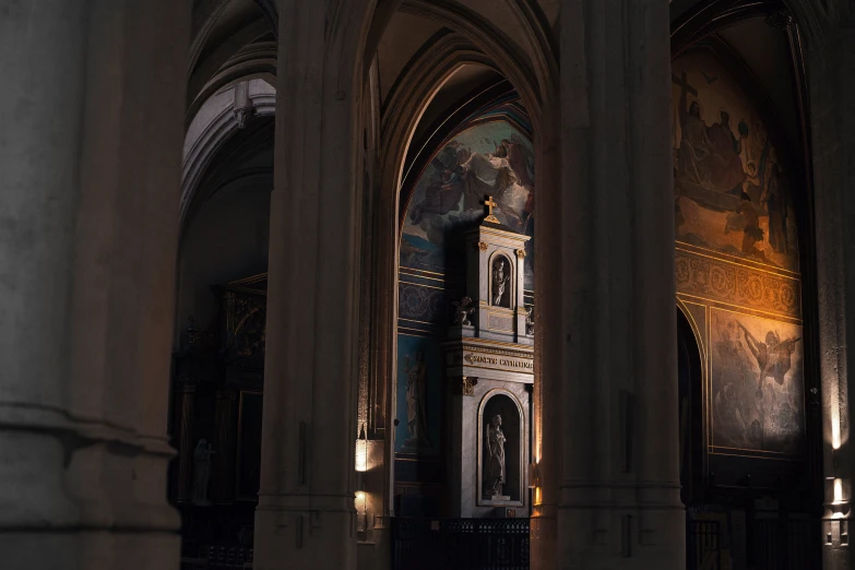 an old clock tower stands among columns of a cathedral