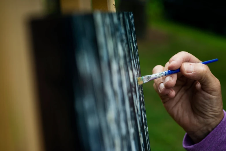 a hand that is writing on a board