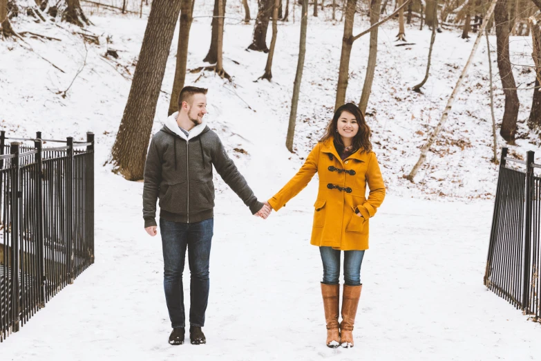 the man and woman are walking through the snow