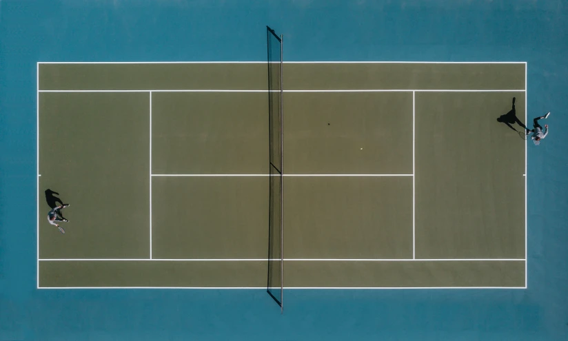 two people playing tennis in the middle of the court