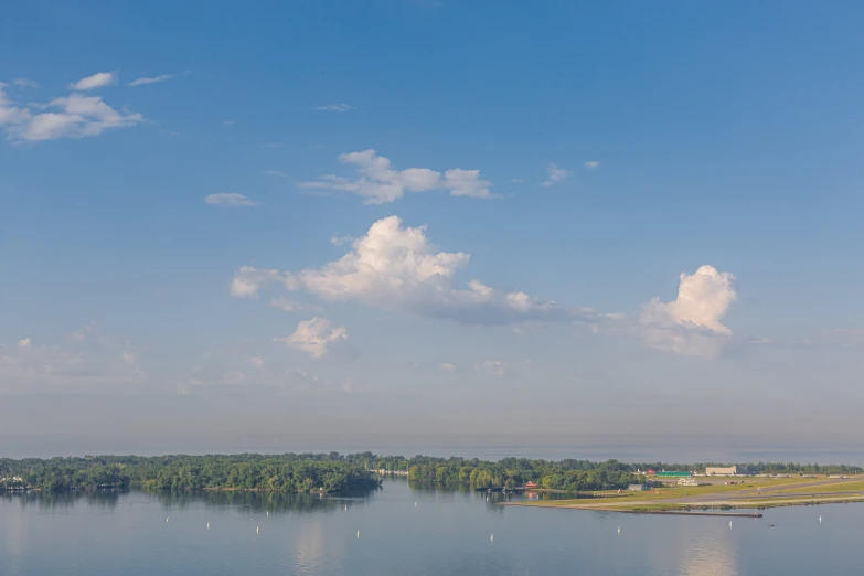 view of a large river and lake with a building on the shore