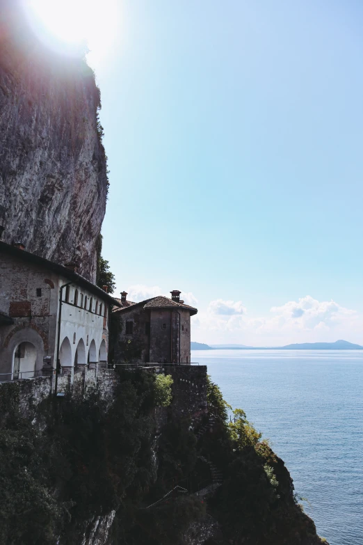 an old building sitting on top of a cliff