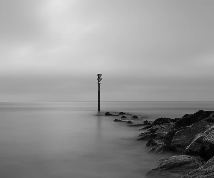 this is an image of a lone light tower in the ocean