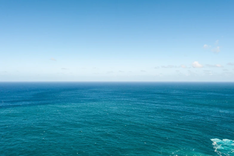 a beautiful blue ocean with some people in the water