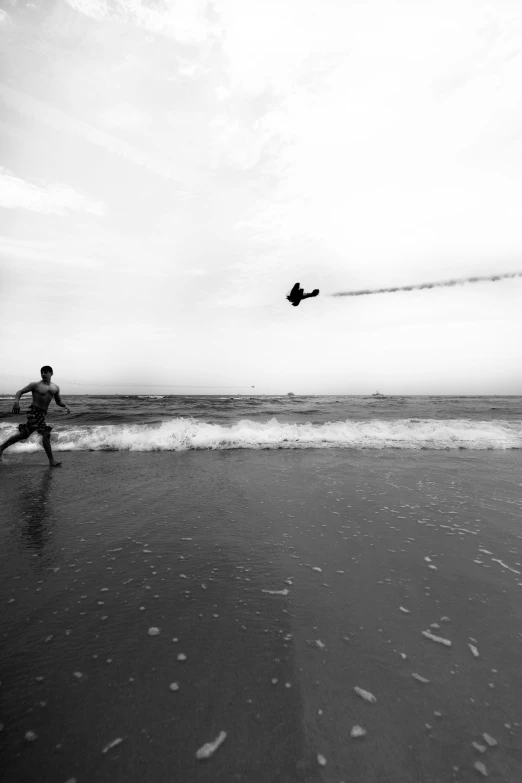 a person kite boarding at the beach on a cloudy day