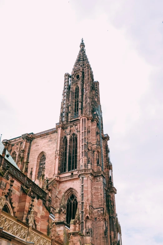 a very tall building with many windows and some stone