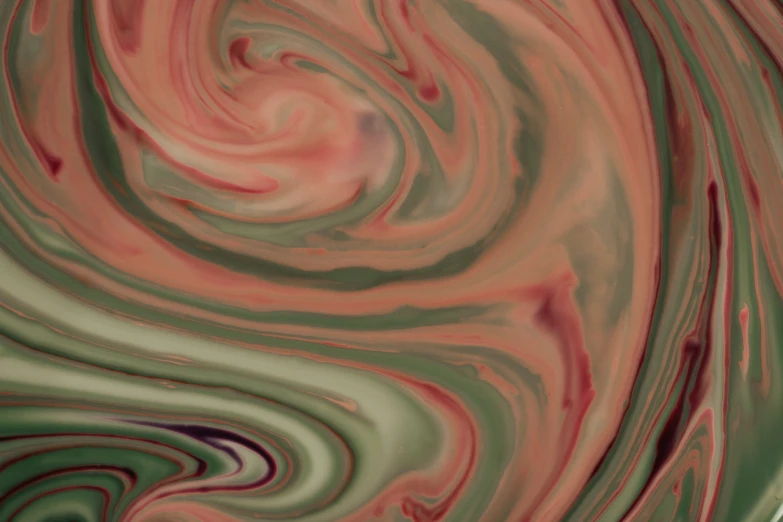 a black, red and green fluidous substance is on a table