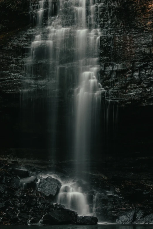 the water is falling down into the stream