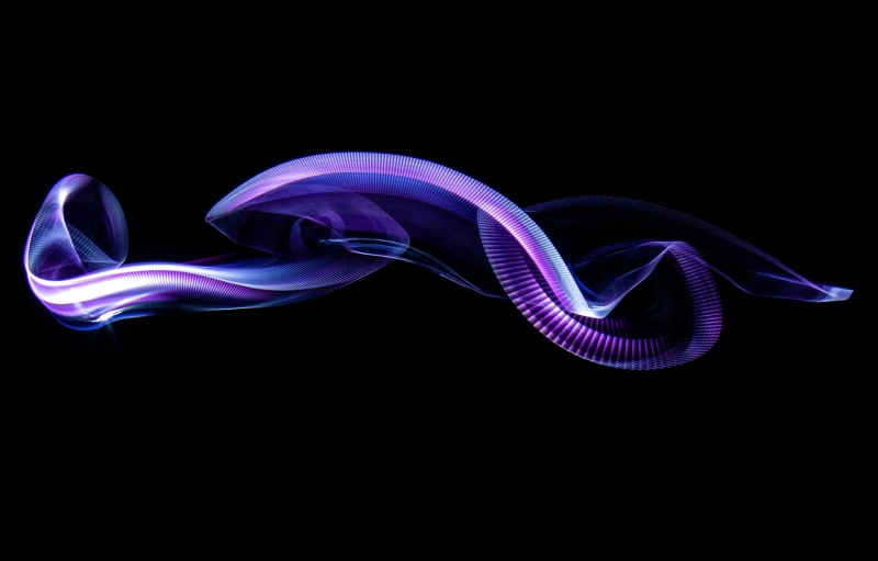 an abstract swirl in purple light on a black background