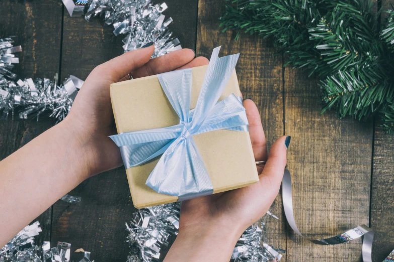 a person's hand is holding an old fashioned wrapped present