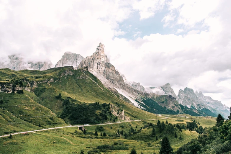 a road that is leading to some mountains