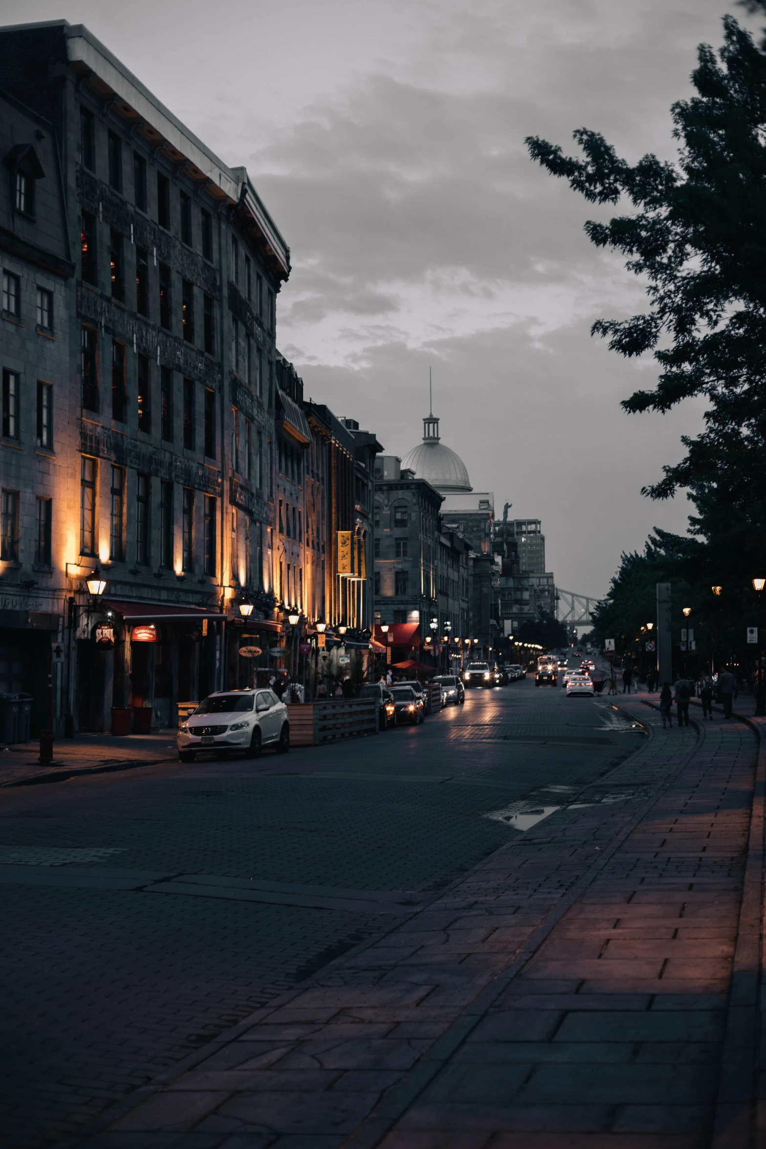 people walking down a city street at night