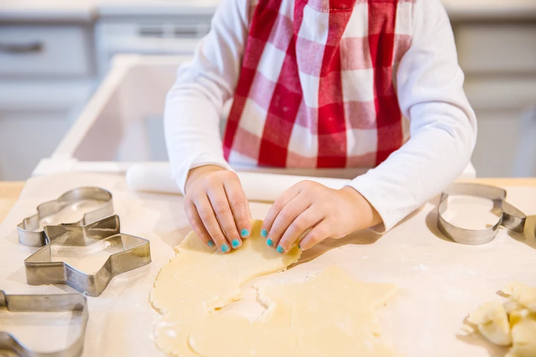 a woman at the kitchen preps the dough