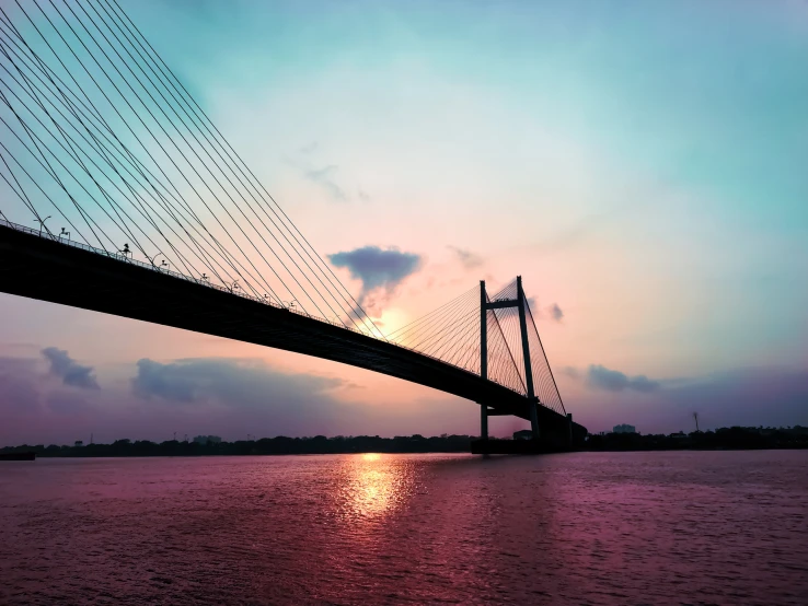 a bridge with lights in the sky over the water