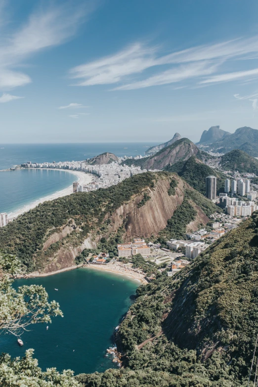 an aerial view of a town on a hillside near the ocean