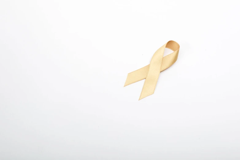 a gold ribbon that is on a white background